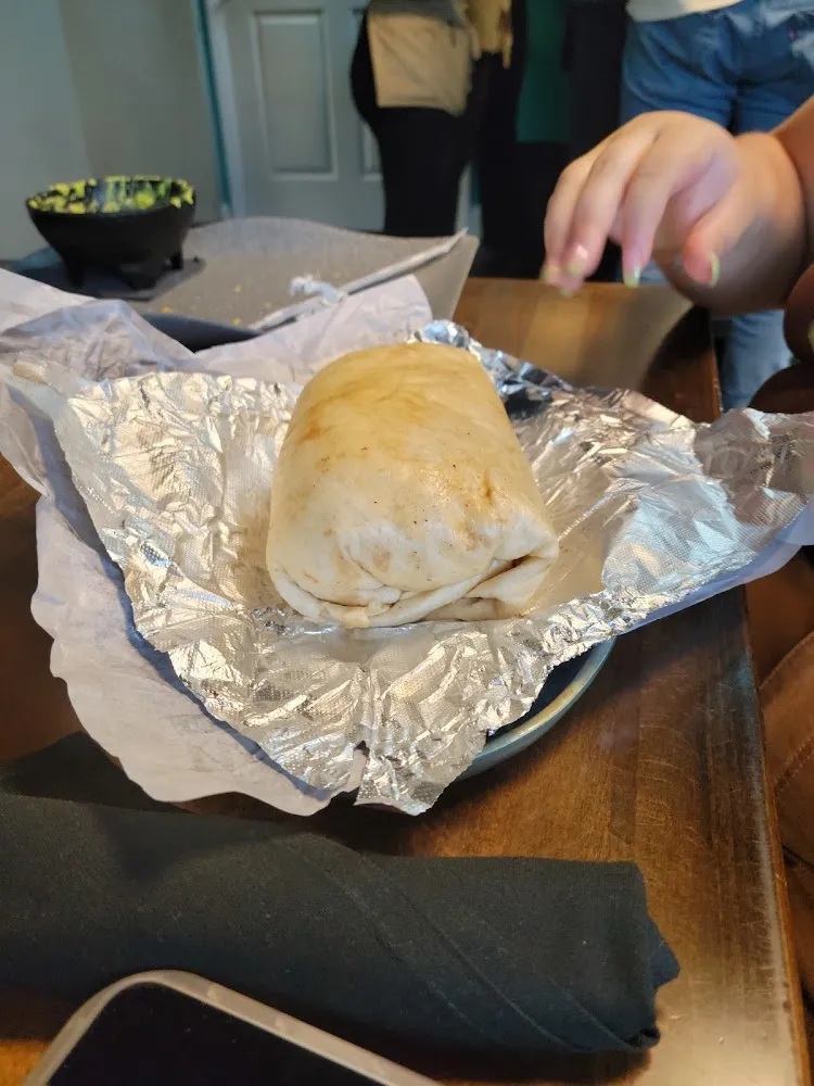 Custom Burrito Made with Tomatillo and Herb Rice Chorizo and Egg Chicken and Queso Fresco